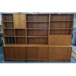 A retro teak three section wall unit having sliding doors, drawers and a fall flap Location: