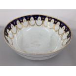 A large 19th century porcelain punch bowl having a blue border with gilt swags below, 12cm h x