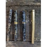 A group of four fountain pens to include a Sheaffer pen with gold plated case and a 14K gold nib,