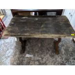 A wooden plank top pub table on cast iron trestle and base 71cm x 105cm x 62cm Location: