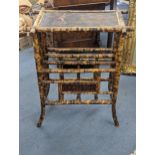 A 19th century bamboo Canterbury/magazine rack having decorated Japanned top depicting a bird