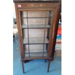 An Edwardian mahogany inlaid display cabinet having three shelves and two glass windows and one