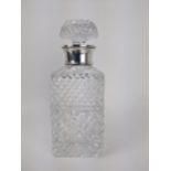A Mills & Hersey glass spirits decanter with a silver collar, London 1973, with line cut decoration,