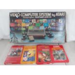 A 1980's Atari video computer system in original box together with four boxed games; Combat,