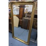 A modern gilded mirror having a moulded frame and bevelled glass, 136h x 75w, Location: