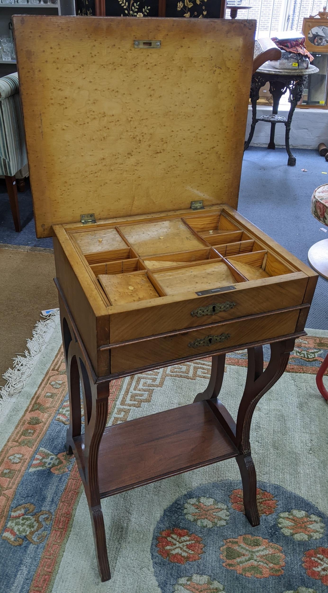 A 19th century French work table having a hinged top, two drawers and shelf below, 77h x 49.5w,