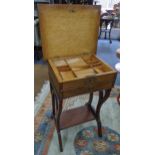 A 19th century French work table having a hinged top, two drawers and shelf below, 77h x 49.5w,