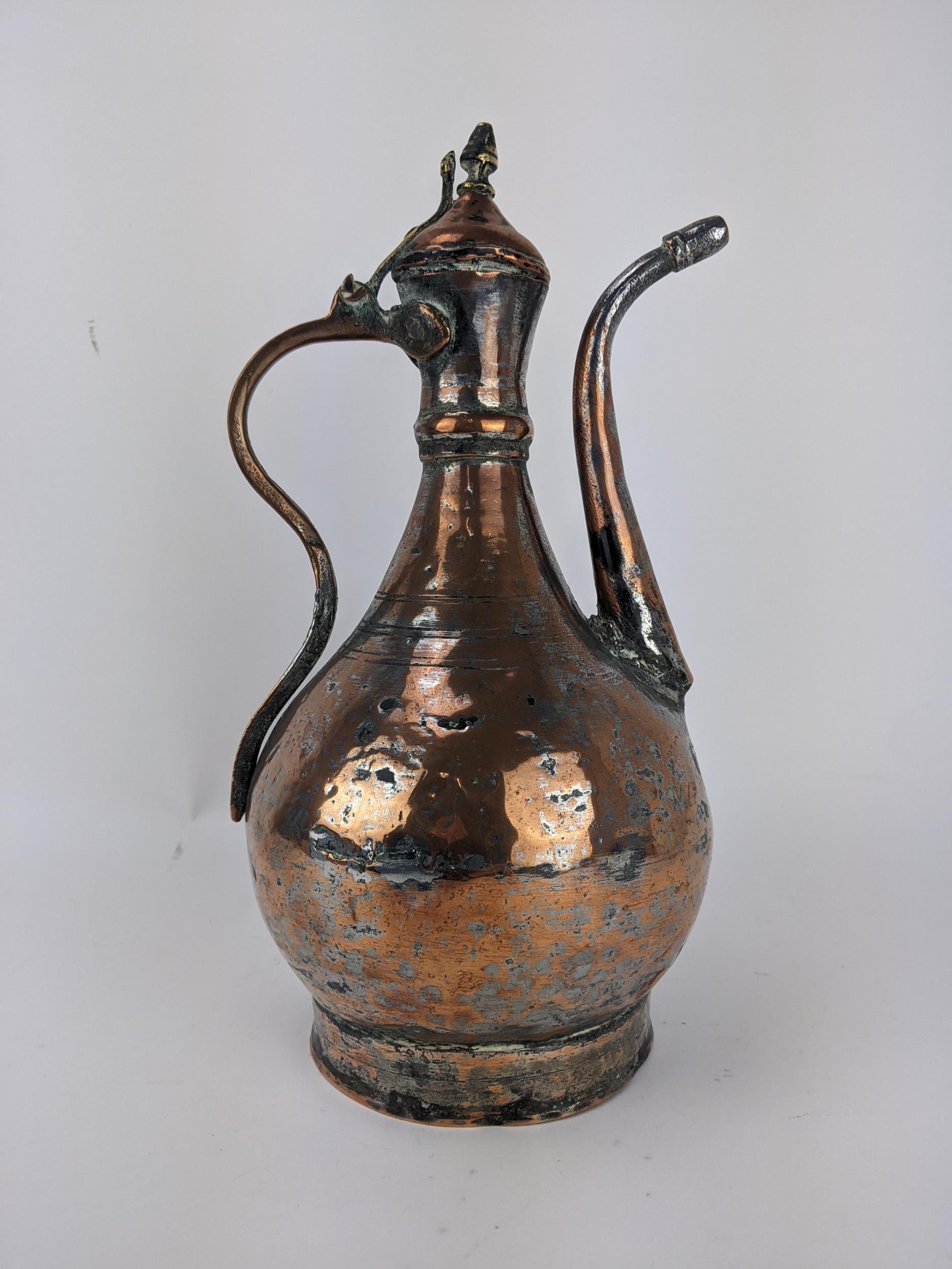 An 18th century Persian copper and brass Dallah, with a hinged lid on curved spout, 36cm high, - Image 2 of 3