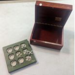 A mahogany inlay box having a Rolex plaque to the interior, along with a desk top Asprey Noughts and
