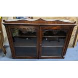 A 19th century mahogany two door glazed wall hanging cabinet, having carved fretwork and two loose