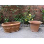 Two terracotta garden planters, one from the Whichford Pottery Warwickshire, oval with a raised band