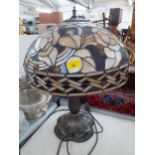A Tiffany style table lamp, the shade in tones of brown with inset amber coloured beads, Location: