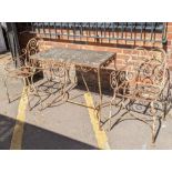 A vintage wrought iron garden table with a marble top and a pair of matching chairs Location: