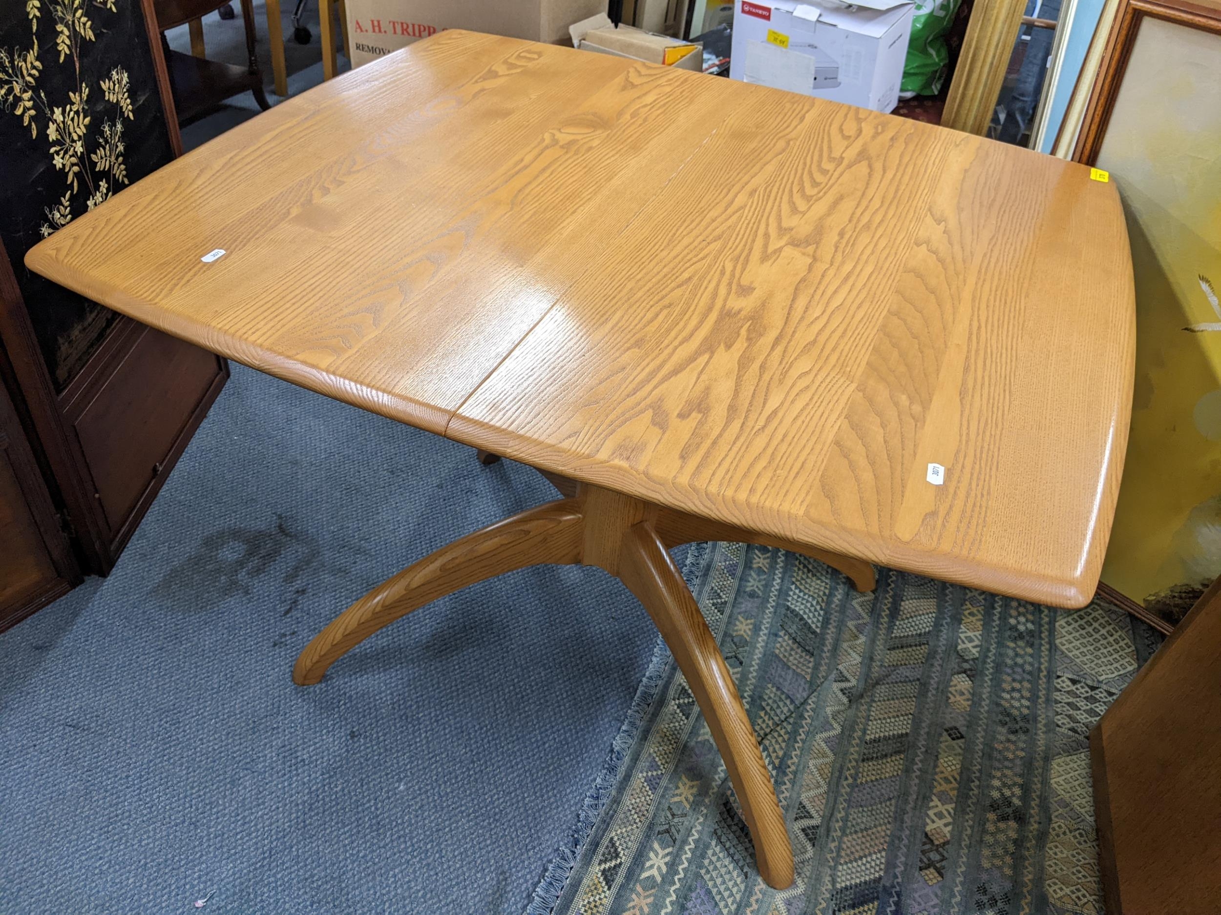 An Ercol Windsor elm extending dining table, model 1992, 73cm h x 104cm w, together with a set of - Image 2 of 3