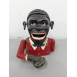 An early 20th century cast metal money box fashioned as an African man Location: These items are