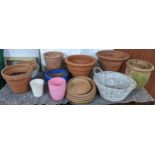 A collection of mainly terracotta plant pots, together with a wicker basket Location: