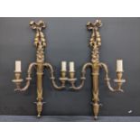 A pair of Louis XVI style two branch wall lights having ribbon motifs to the top, 75cm h Location: