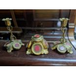 A Victorian gilt metal desk inkwell and candlesticks set, each piece with engraved decoration, and
