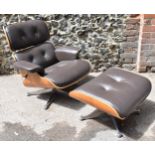 A vintage brown leather armchair and ottoman, after the design by Charles and Ray Eames for Herman