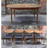 A mid century extending teak dining table, d-ended, together with a set of eight dining chairs