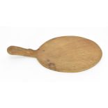 Robert Thompson of Kilburn (1876-1955) Mouseman- an oval oak cheese board, with carved signature