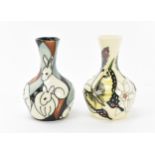 Two Modern Moorcroft pottery bud vases, one in the 'pole to pole rabbits' pattern designed by
