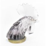 A Lalique 'Tete de Coq' Car Mascot, in clear lilac glass modelled as a cockerel head, with metal