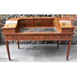 An Edwardian satinwood Carlton House desk, in the Sheraton style, with leather writing surface,