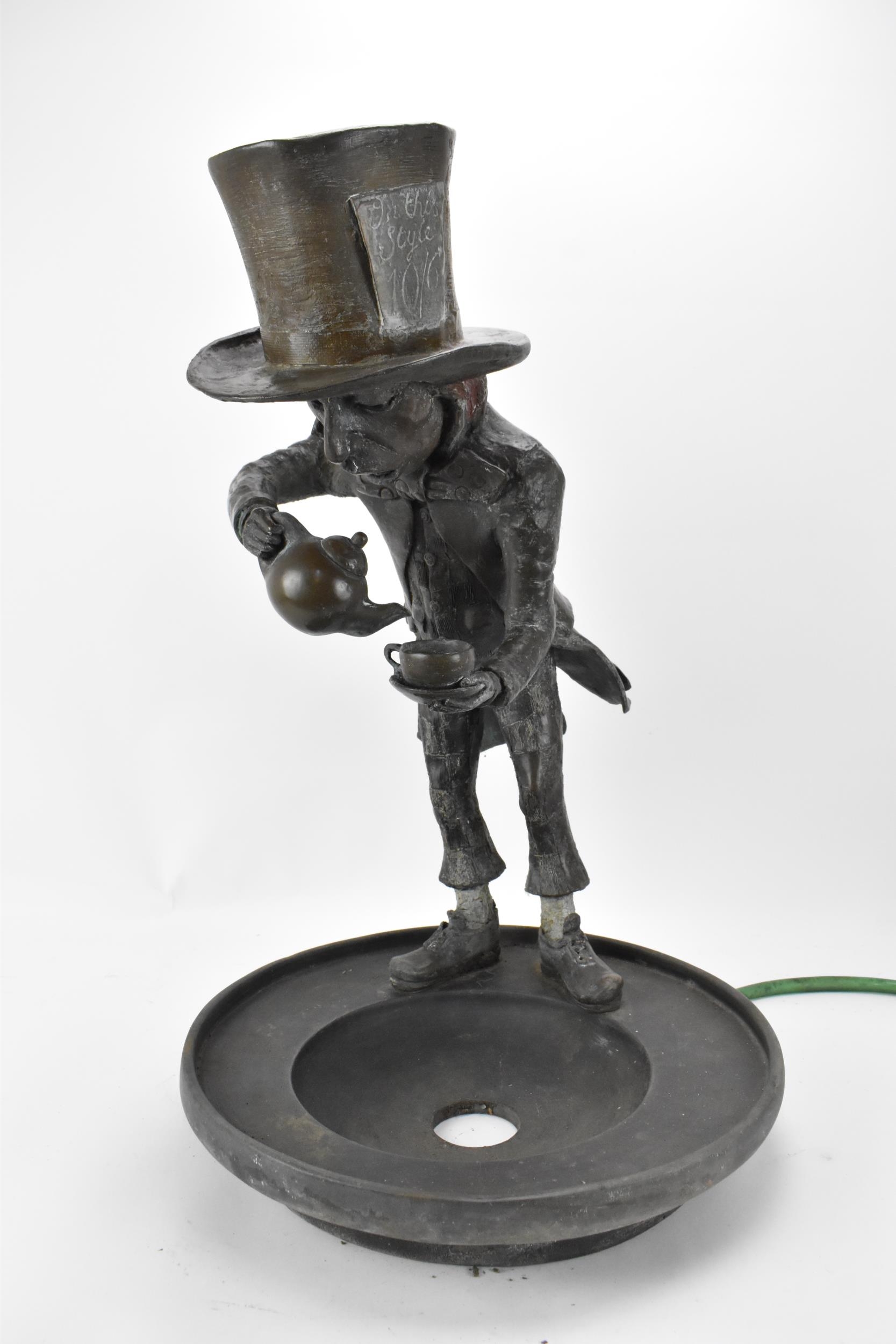 A cold cast bronze sculptural water feature of Alice in Wonderland's Mad Hatter, by Robert James