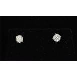 A pair of solitaire diamond earrings, the brilliant cut stones approx 0.30 carat, in a four claw