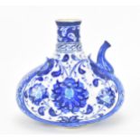 A Turkish iznik style blue and white pottery water bottle, with foliate pattern and short spout,