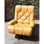 A 1970s Danish Tetrad Nucleus swivel armchair, in yellow/light tan leather, thick padded seat and