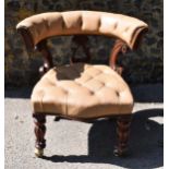 An early Victorian mahogany and leather captain's desk chair, with buttoned tan leather backrest and