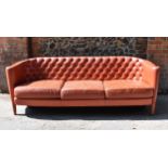 A mid century Italian leather three seater sofa by Minotti, designed by Rodolfo Dordoni, in red