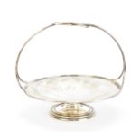 A small Edwardian silver basket by Asprey, London 1908, with pierced looped handle, circular faceted