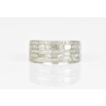 An 18ct white gold and diamond set dress ring, designed with four alternating rows of pave set