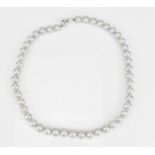 An 18ct white gold and single strand cultured Tahitian pearl necklace, of light grey colour,