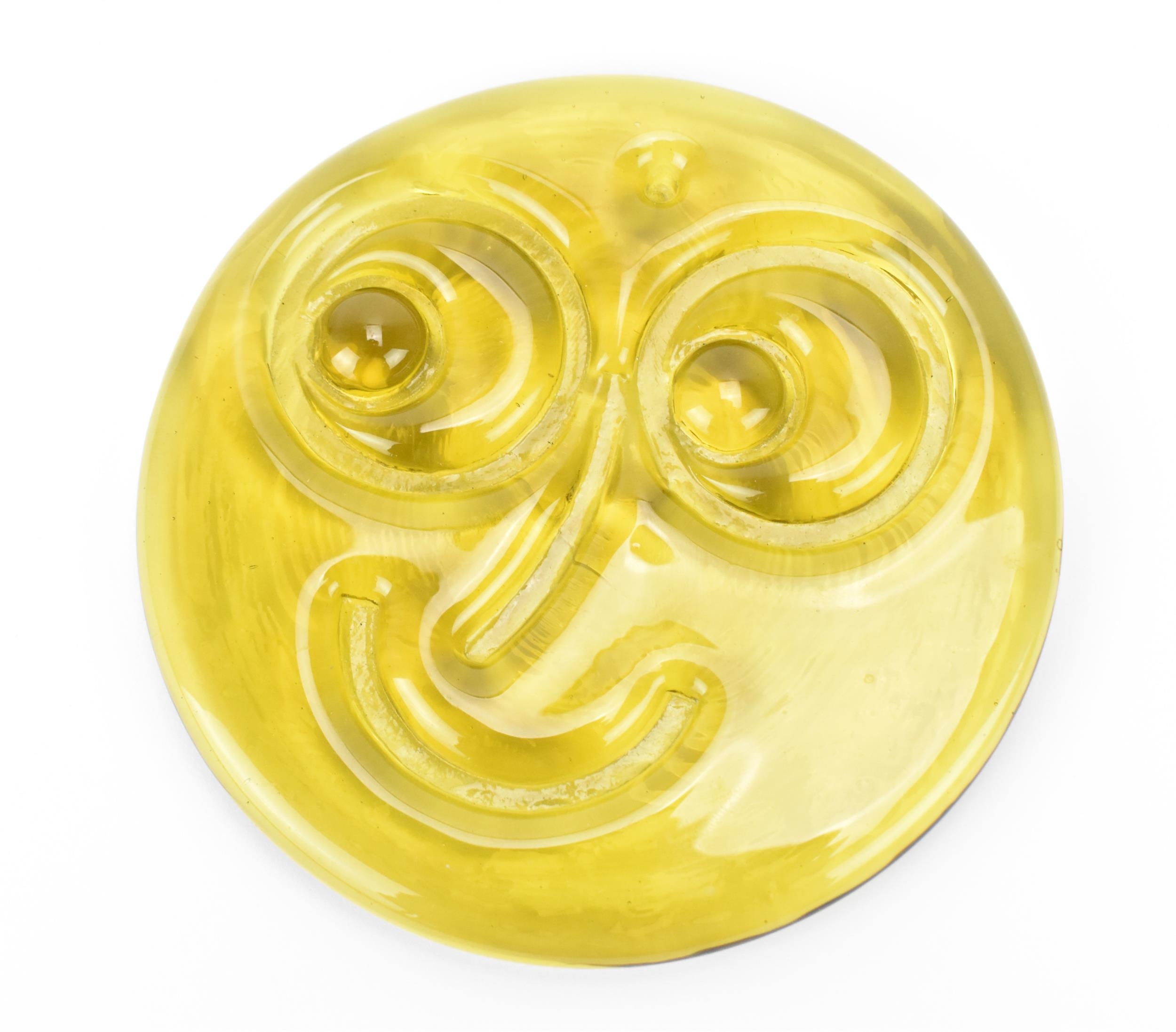 A rare Whitefriars glass smiley face suncatcher, designed by Alfred Fisher, in translucent yellow