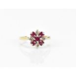 An 18ct yellow gold, platinum, diamond and ruby floral cluster ring, set with five step cut rubies