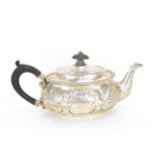 A Victorian silver teapot by John Aldwinckle & Thomas Slater, London 1886, designed with embossed