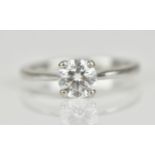 An 18ct white gold and diamond solitaire ring, with central round brilliant cut stone approx 0.87