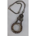 An early to mid 20th Century decorative monocle fashioned as a pendant on a Sterling silver chain.
