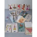 A quantity of vintage postcards, a White Star Cruise Line bookmark, and 5 puzzle games to include