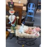 A large metal painted Christmas snowman soldier ornament, 130cm h together with a pram, dolls,