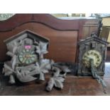 A Swiss Black Forest cased cuckoo clock, and a Bakelite cased wall hanging cuckoo clock Location: