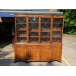 A reproduction mahogany breakfront side unit, the top with twin astragal glazed doors flanked by