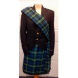 A green and blue tartan ladies kilt together with a ladies black evening jacket having Scottish Lion