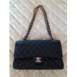 Chanel-A black 'Caviar" lambskin leather Medium Classic double flap bag having an interlocking