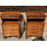 A pair of reproduction mahogany bedside tables, the brush slides and cupboard doors with faux drawer
