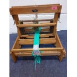 A vintage Weavemore four shaft table top treen loom. Location:RWF